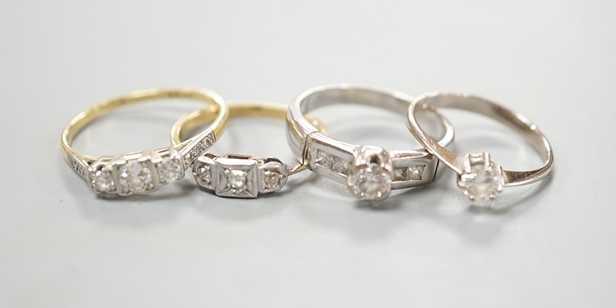 Four assorted diamond dress rings including two 18ct and two white metal, gross 10 grams